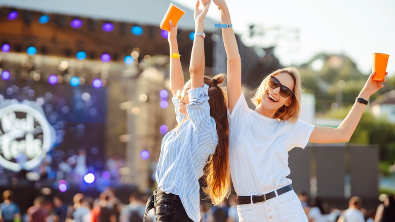 Two women dancing at concert