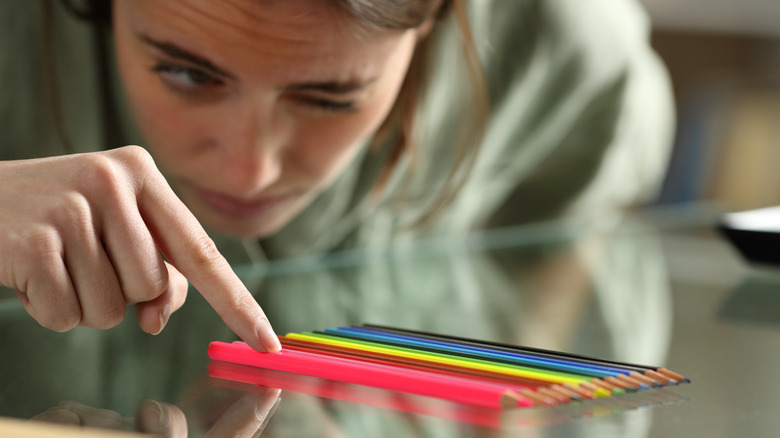 woman arranging pencils perfectly