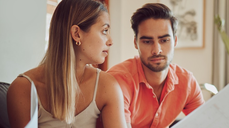 Couple arguing over paperwork