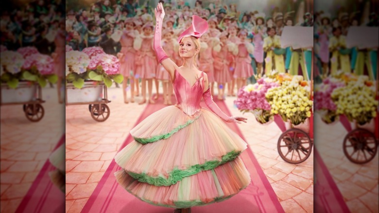 Ariana Grande wearing a pink dress as Glinda in